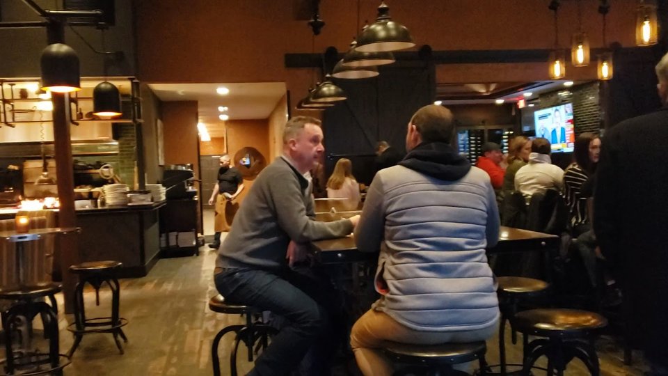 Casual tap house dining area with wooden tables.
